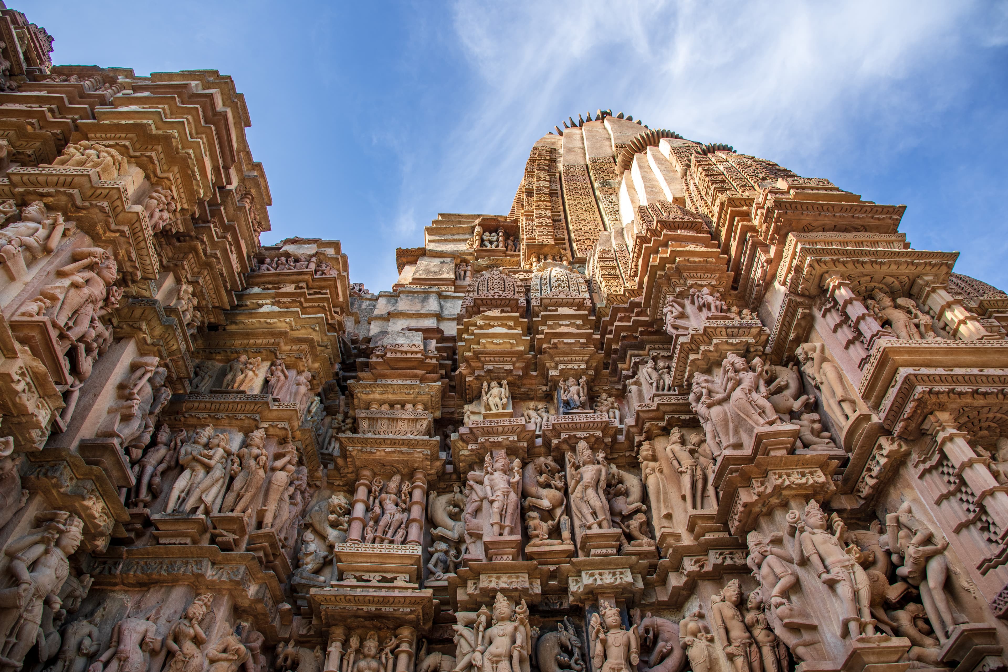 Divine Carvings of Khajuraho Temple Soaring Into Blue Skies