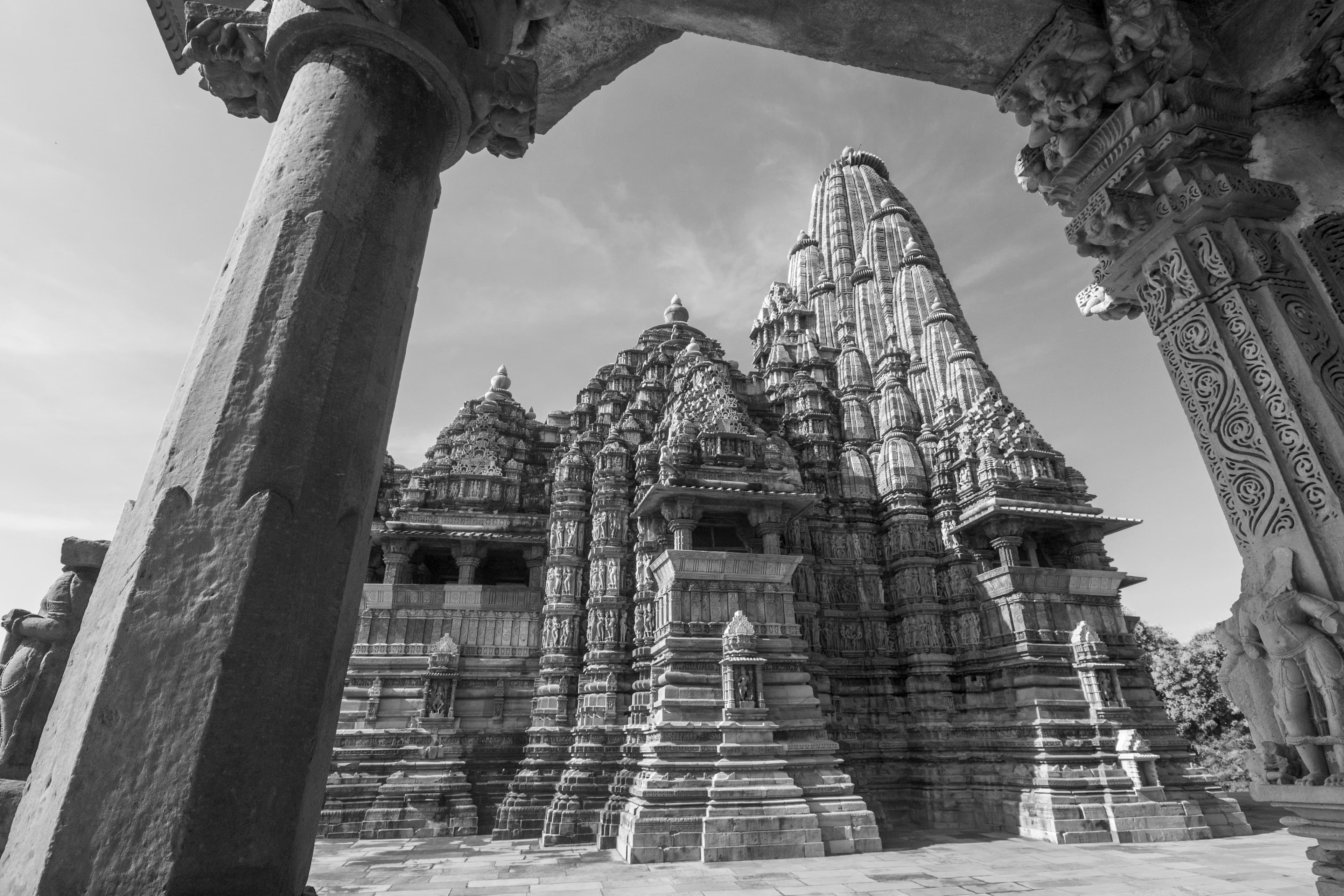 Timeless View of Kandariya Mahadev Temple Framed in Stone – Black & White Elegance