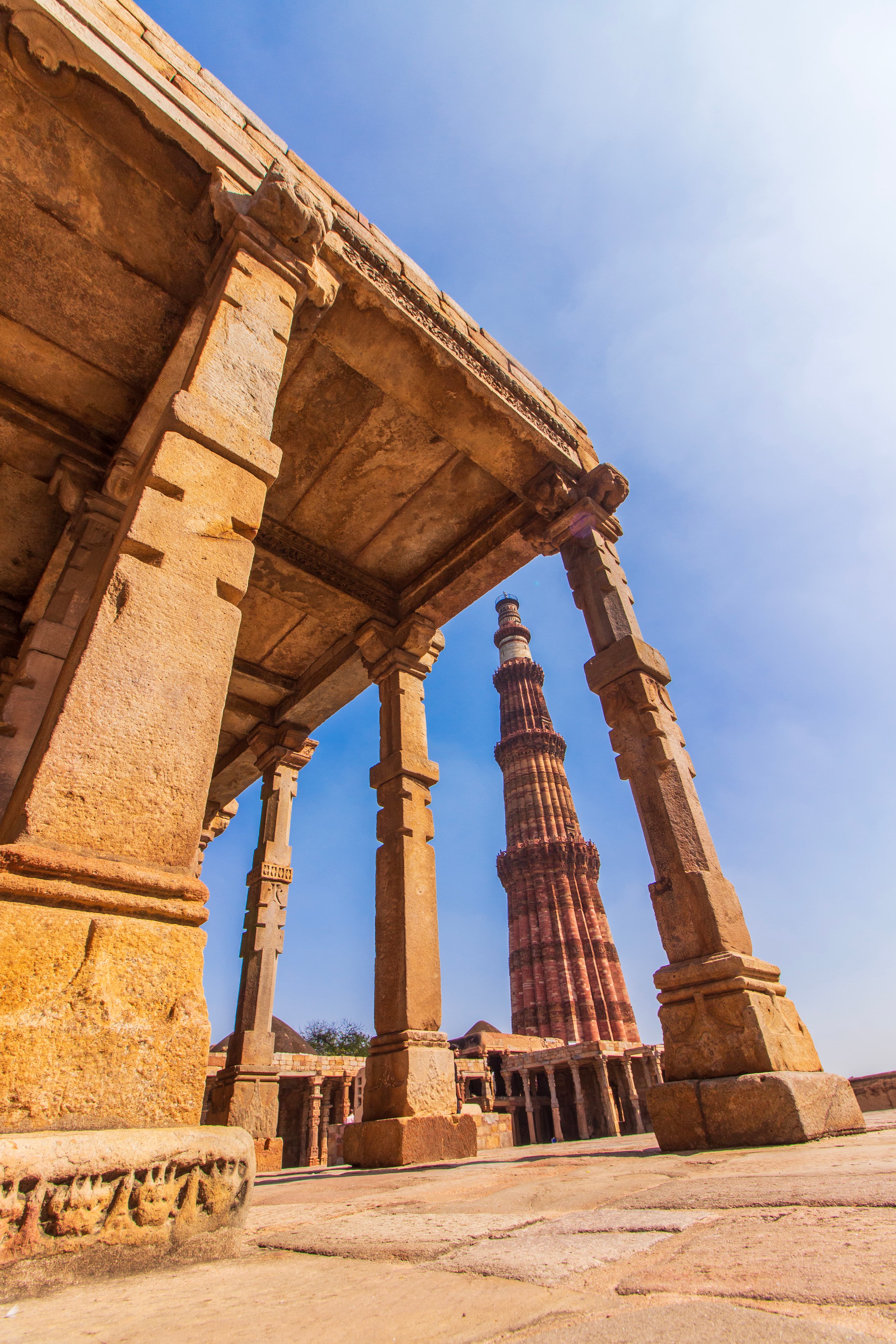 Framed Legacy Qutub Minar Through Ancient Arches