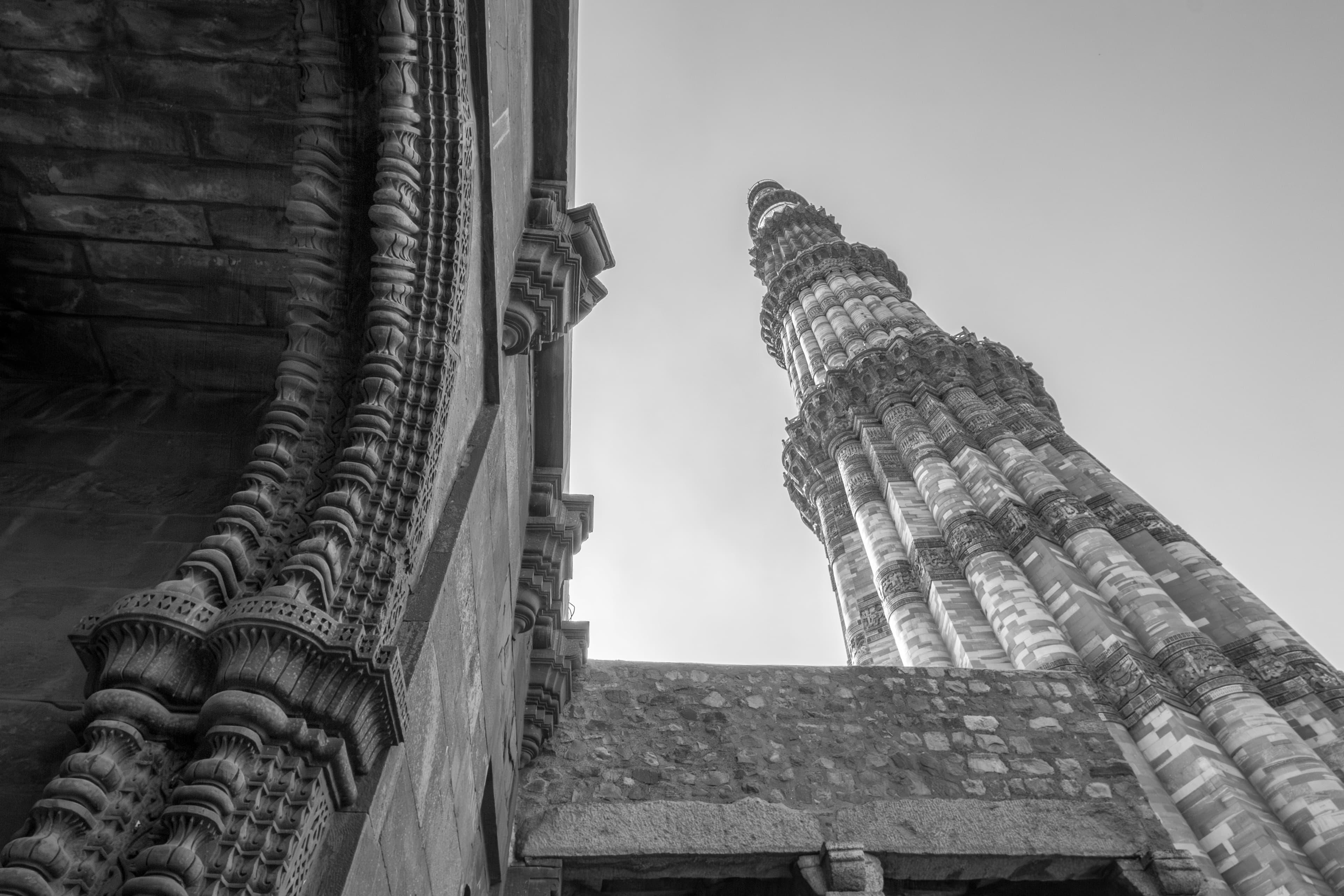 Upward Gaze Qutub Minar Through Arched Heritage