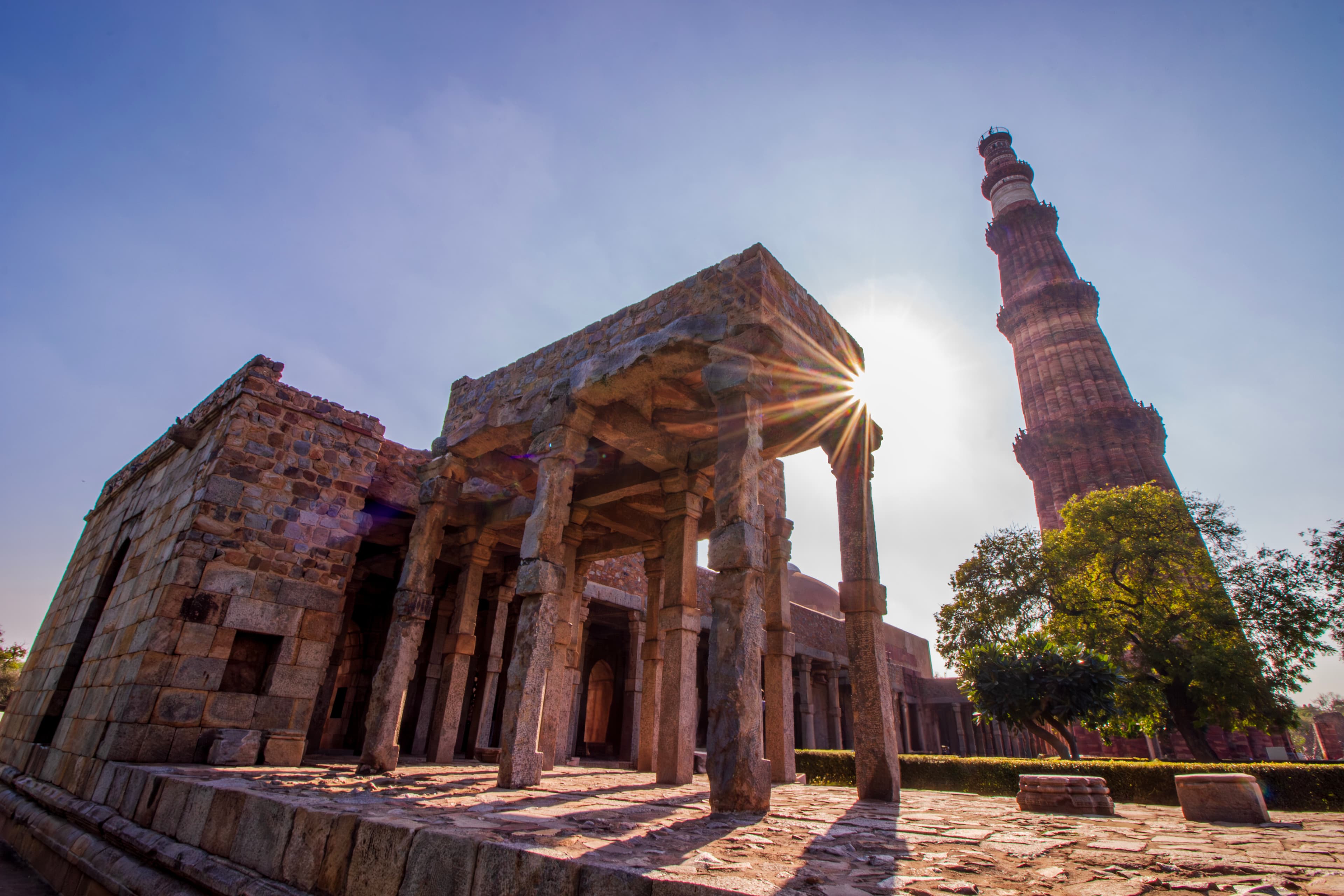 Sunlit Majesty Qutub Minar Framed in Historic Stone