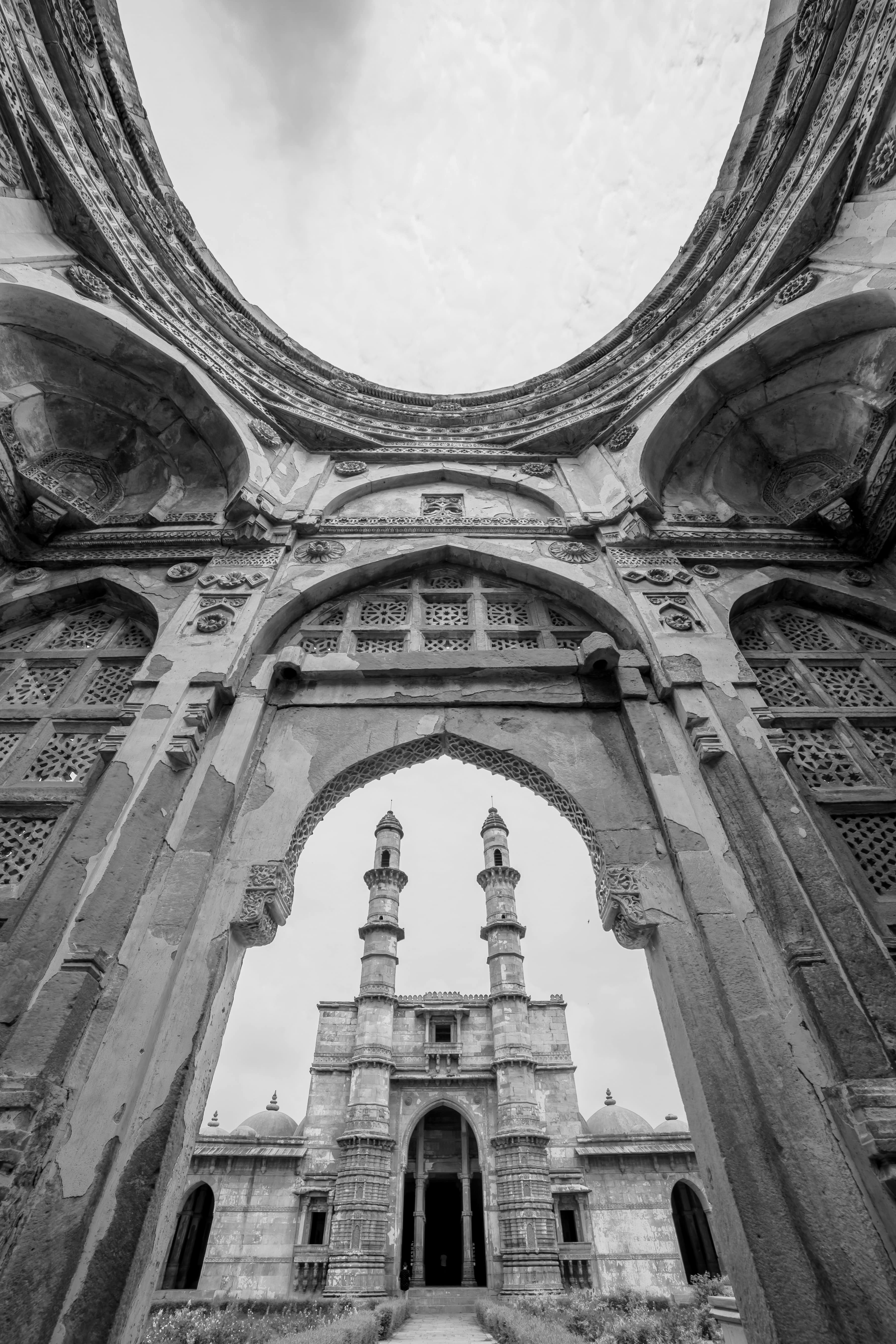 Jami Masjid Minarets Through a Stone Arch